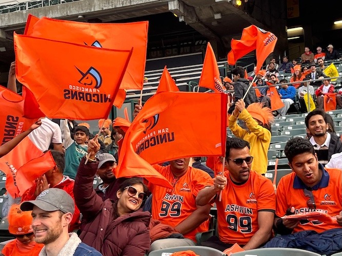 Sparkle Army fans in the stands waving Unicorns flags